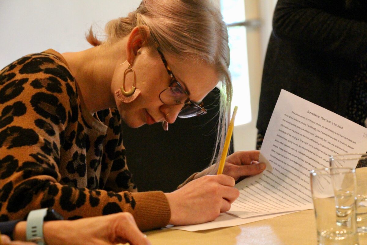 a woman writing on a piece of paper