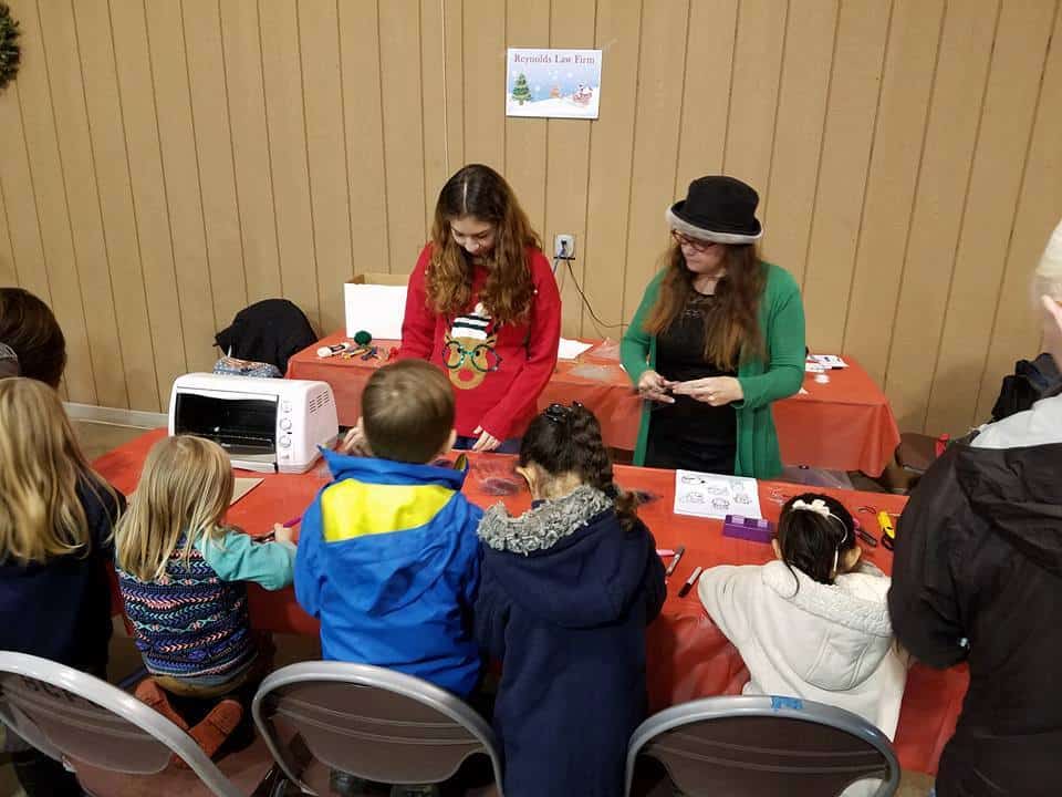 Kids at a table making ornaments